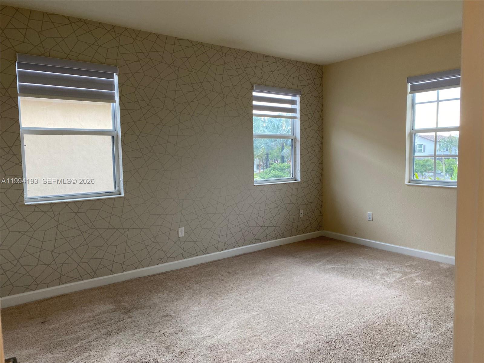 17001 Southwest 90th Terrace, Unit 1 Miami, FL 33196 - Photo 12 of 35 a view of an empty room with a window