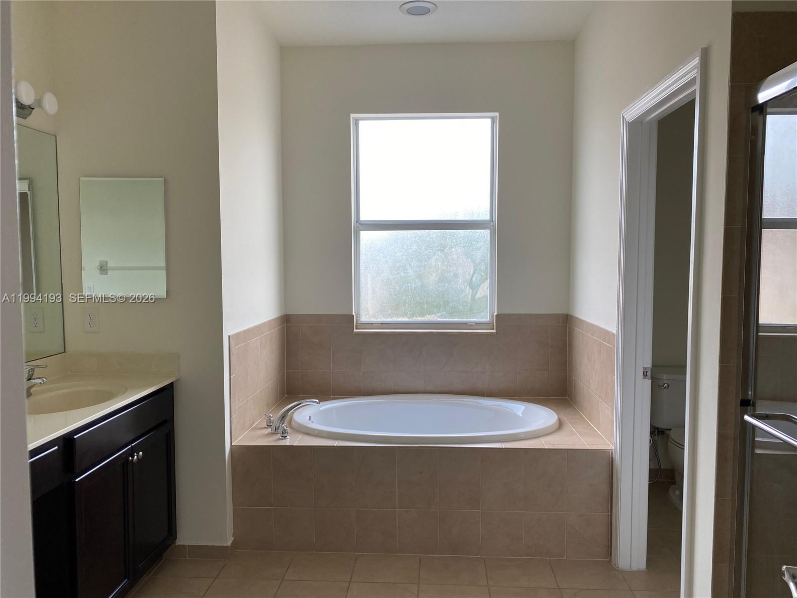 17001 Southwest 90th Terrace, Unit 1 Miami, FL 33196 - Photo 13 of 35 a bathroom with a sink and a toilet