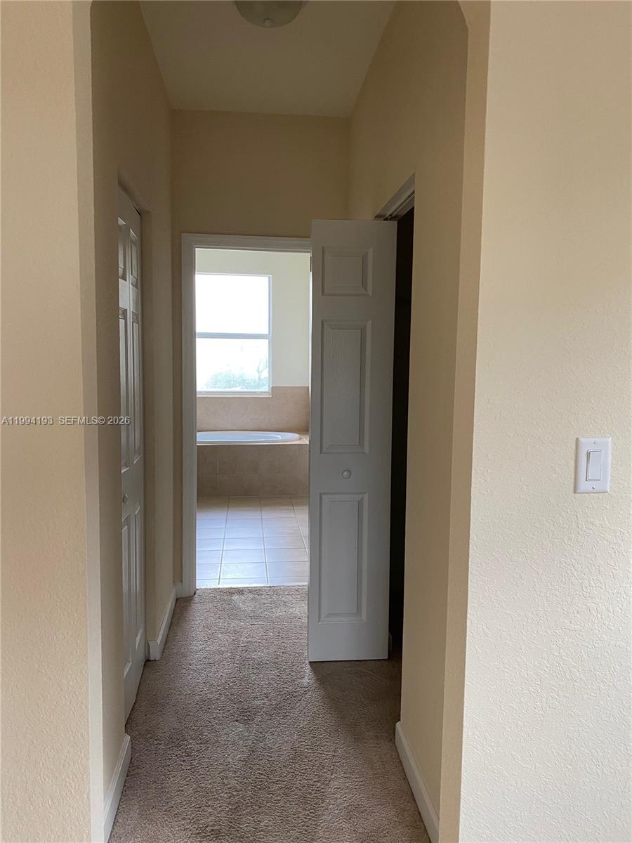 17001 Southwest 90th Terrace, Unit 1 Miami, FL 33196 - Photo 16 of 35 a view of a hallway