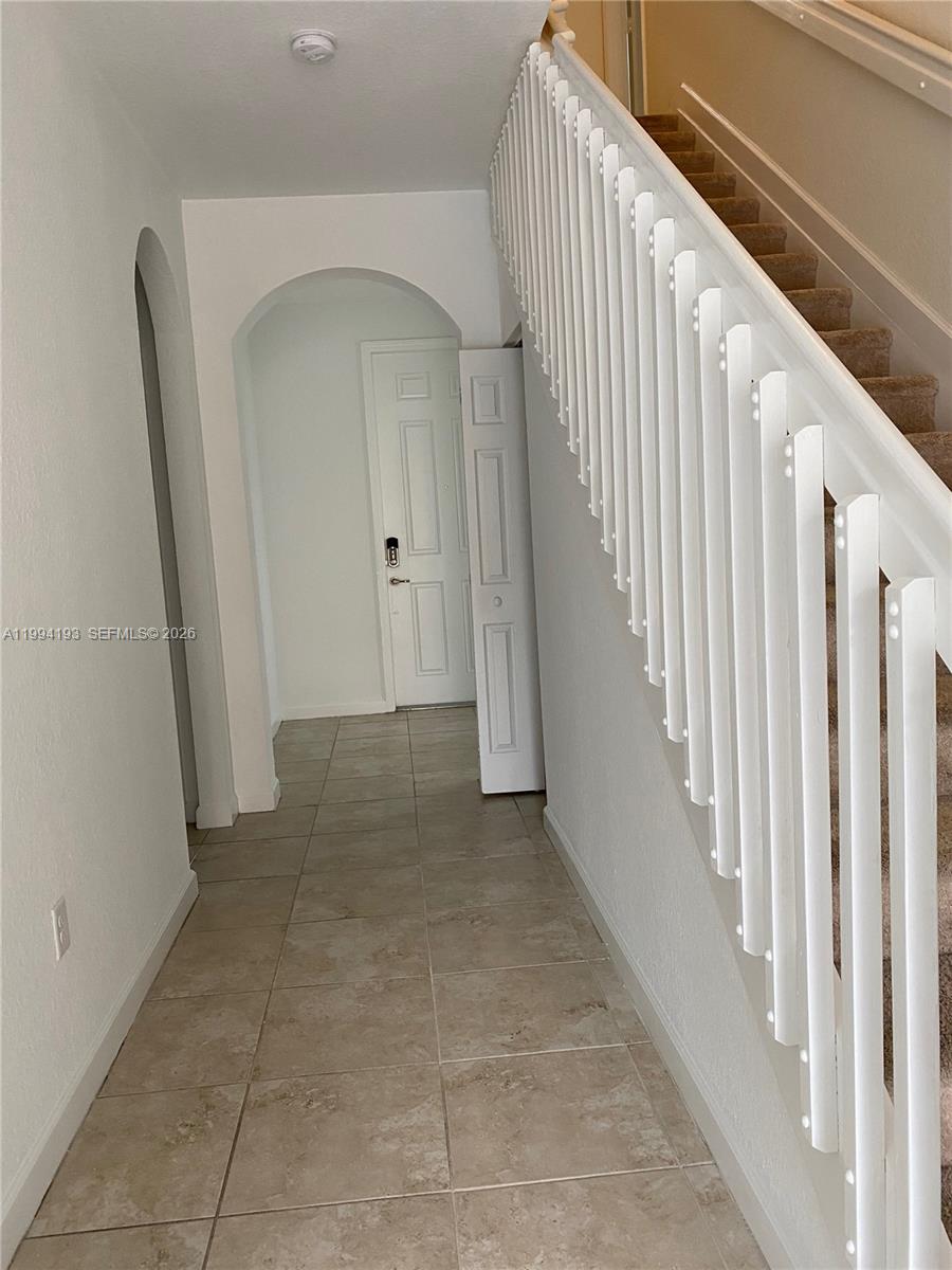 17001 Southwest 90th Terrace, Unit 1 Miami, FL 33196 - Photo 20 of 35 a view of a hallway view with staircase
