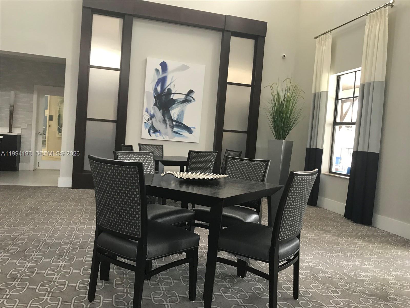 17001 Southwest 90th Terrace, Unit 1 Miami, FL 33196 - Photo 26 of 35 a view of a dining room with furniture and a potted plant