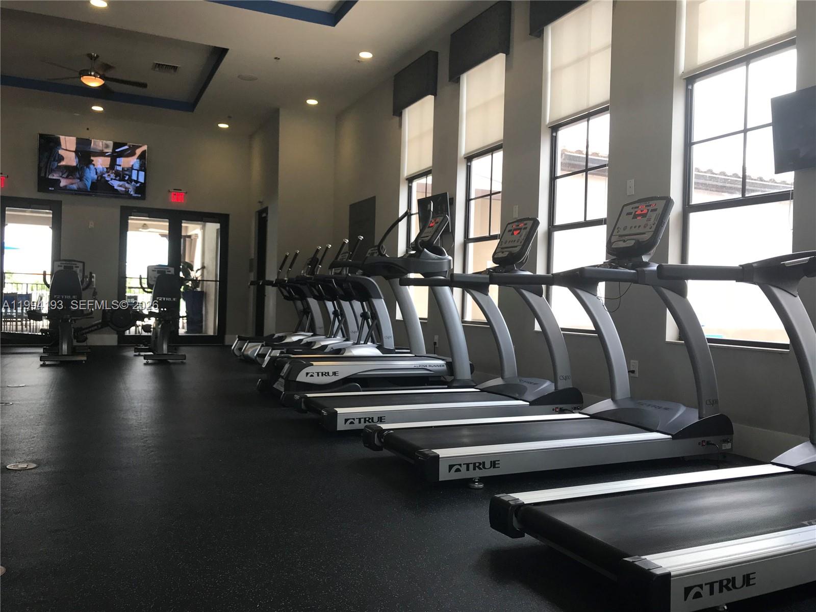 17001 Southwest 90th Terrace, Unit 1 Miami, FL 33196 - Photo 31 of 35 a view of gym room with lots of gym equipment