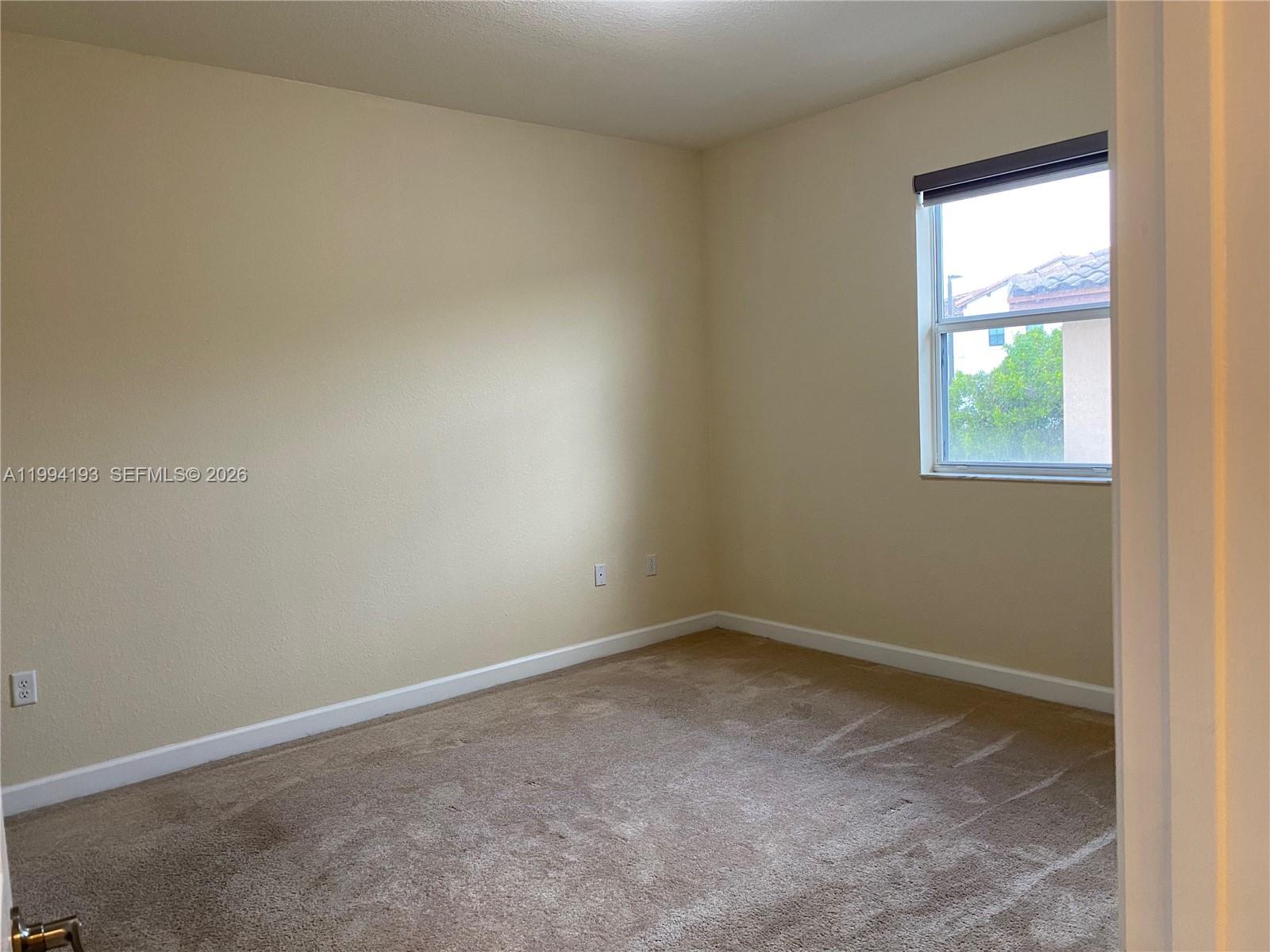17001 Southwest 90th Terrace, Unit 1 Miami, FL 33196 - Photo 6 of 35 an empty room with a window
