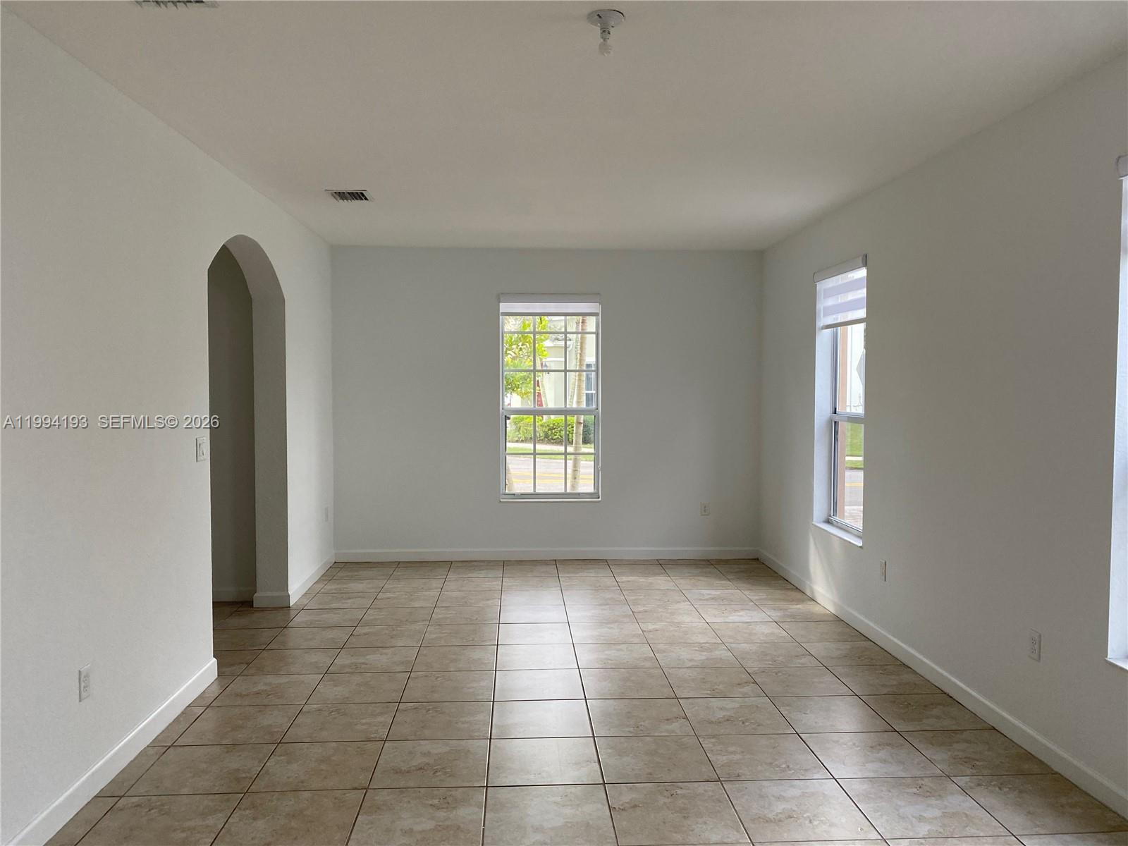 17001 Southwest 90th Terrace, Unit 1 Miami, FL 33196 - Photo 7 of 35 an empty room with windows and closet