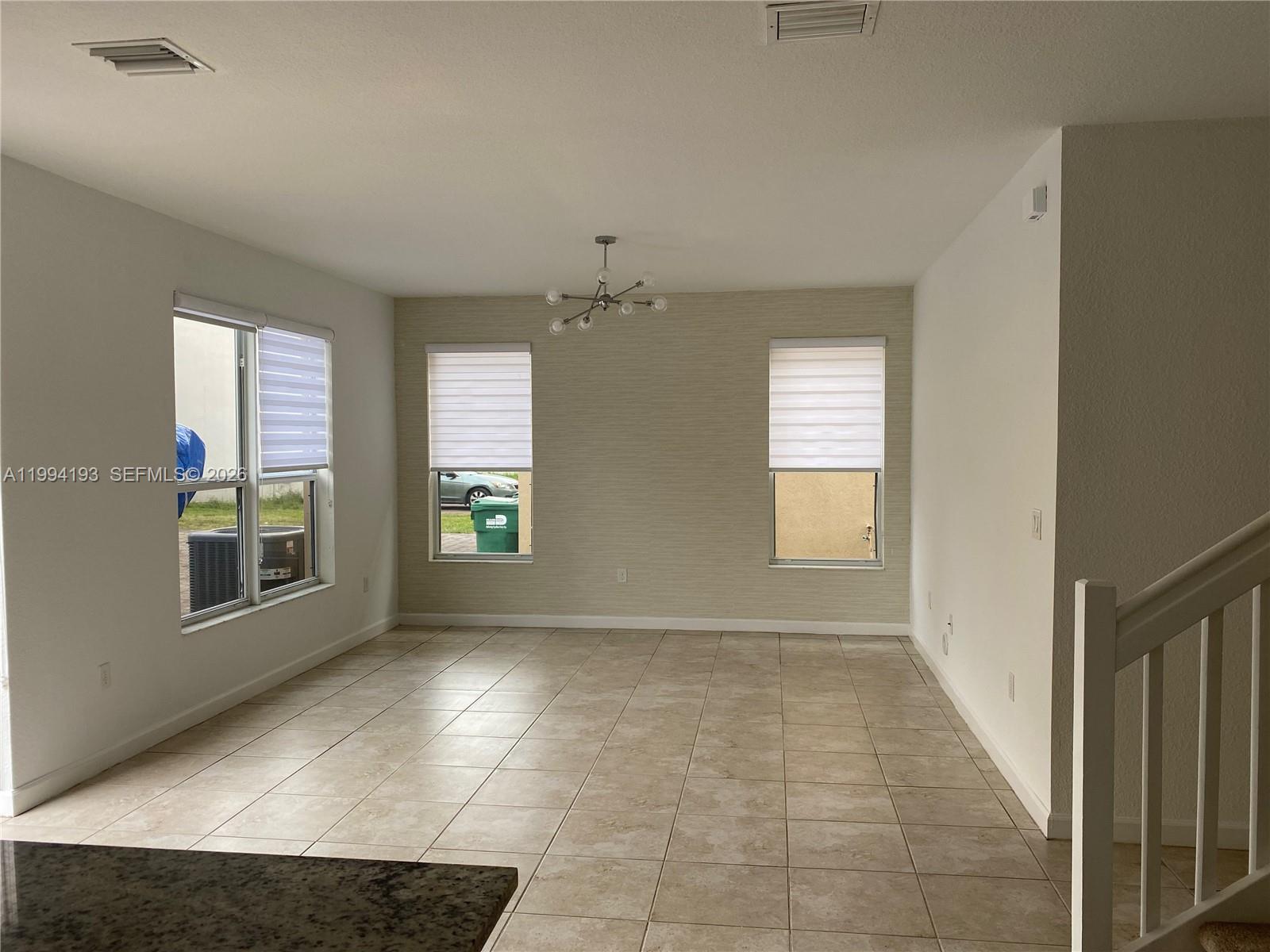 17001 Southwest 90th Terrace, Unit 1 Miami, FL 33196 - Photo 8 of 35 a view of an empty room with a window