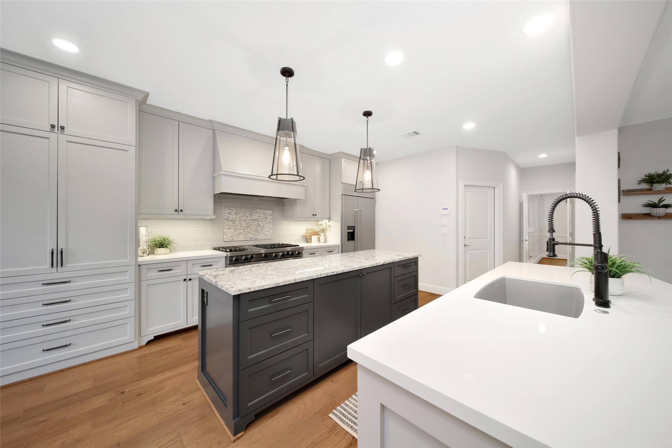 20730 Windrose Bend Drive Spring, TX 77379 - Photo 23 of 50 a kitchen with granite countertop a sink stainless steel appliances and white cabinets