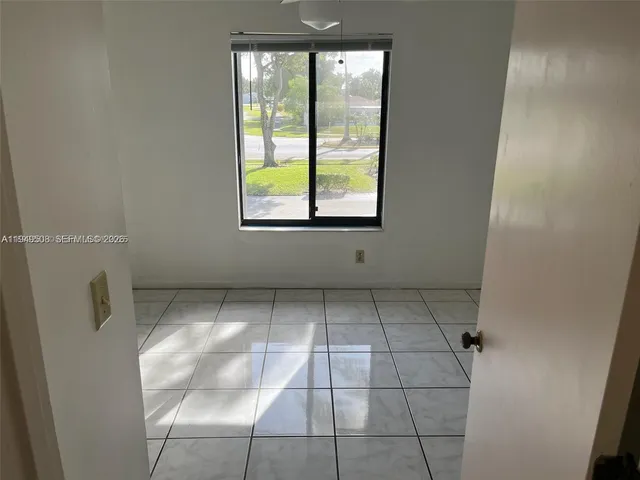 a view of an empty room with a window