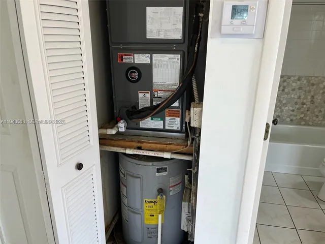 a bathroom with a granite countertop bathtub shower sink vanity and toilet