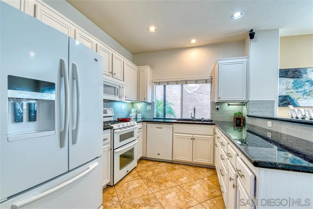 1314 Mill Valley Road Chula Vista, CA 91913 - Photo 11 of 25 a kitchen with stainless steel appliances granite countertop a stove a sink and a refrigerator