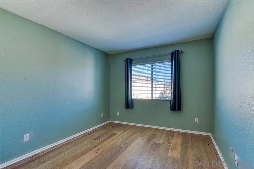 1314 Mill Valley Road Chula Vista, CA 91913 - Photo 16 of 25 an empty room with wooden floor and windows