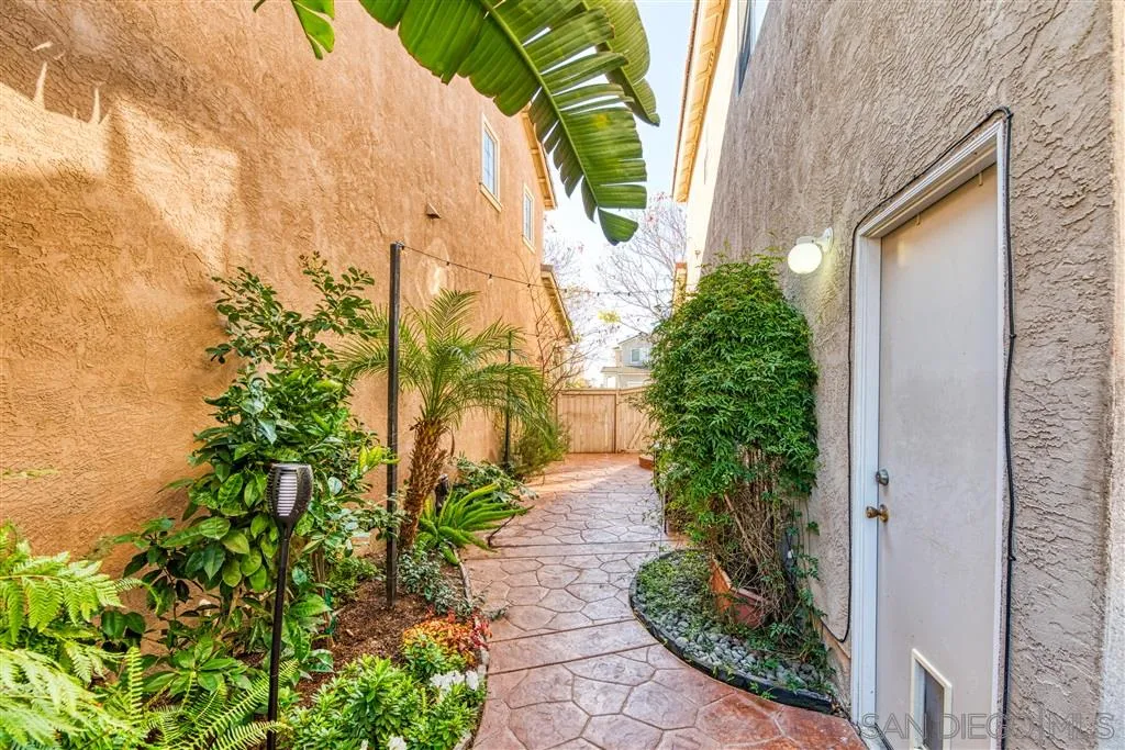 1314 Mill Valley Road Chula Vista, CA 91913 - Photo 19 of 25 a view of a pathway with flower plants and wooden fence