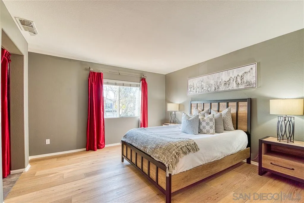 1314 Mill Valley Road Chula Vista, CA 91913 - Photo 22 of 25 a bedroom with a bed a lamp and a large window