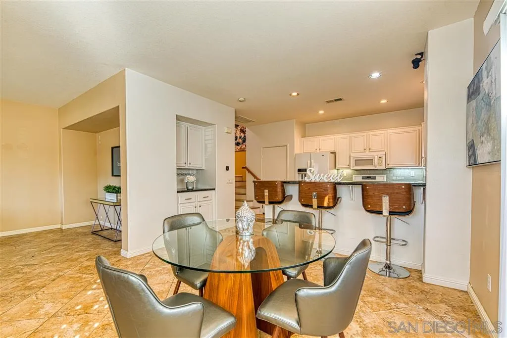 1314 Mill Valley Road Chula Vista, CA 91913 - Photo 6 of 25 a dining room with furniture a rug and kitchen view