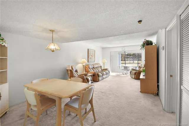 a living room with furniture a chandelier and a chandelier