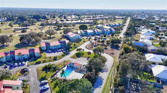 an aerial view of residential houses with outdoor space