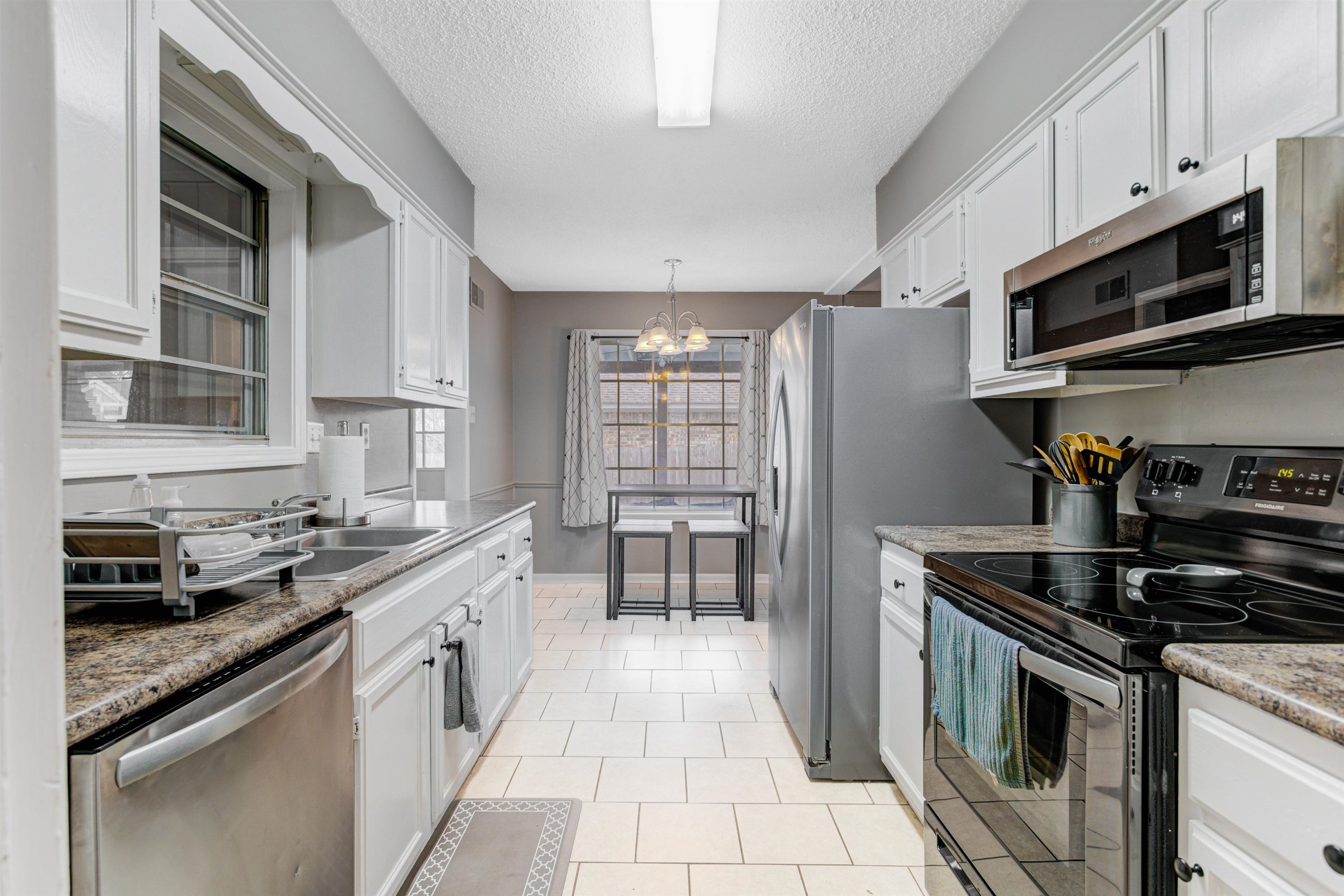 3224 Court Street Bartlett, TN 38134 - Photo 7 of 23 a kitchen with stainless steel appliances granite countertop a stove and a refrigerator