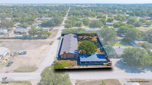 an aerial view of houses with yard
