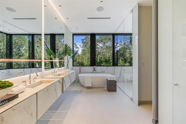 a bathroom with a large tub and large window
