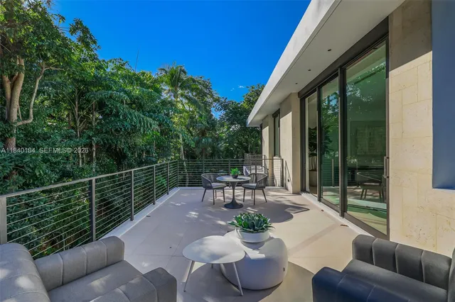 a view of a patio with couches table and chairs and potted plants