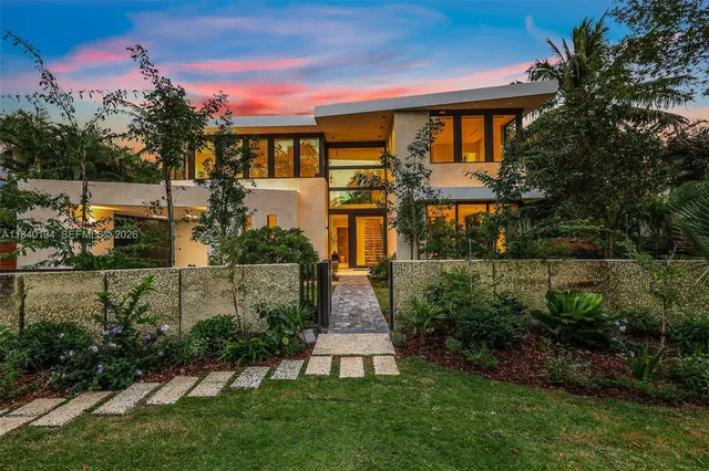 a front view of a house with a garden