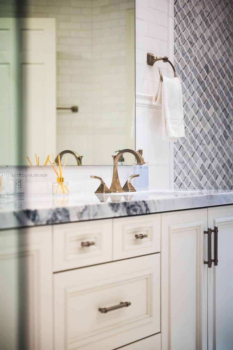 570 Manor Road Maitland, FL 32751 - Photo 33 of 100 a bathroom with a granite countertop sink and a mirror