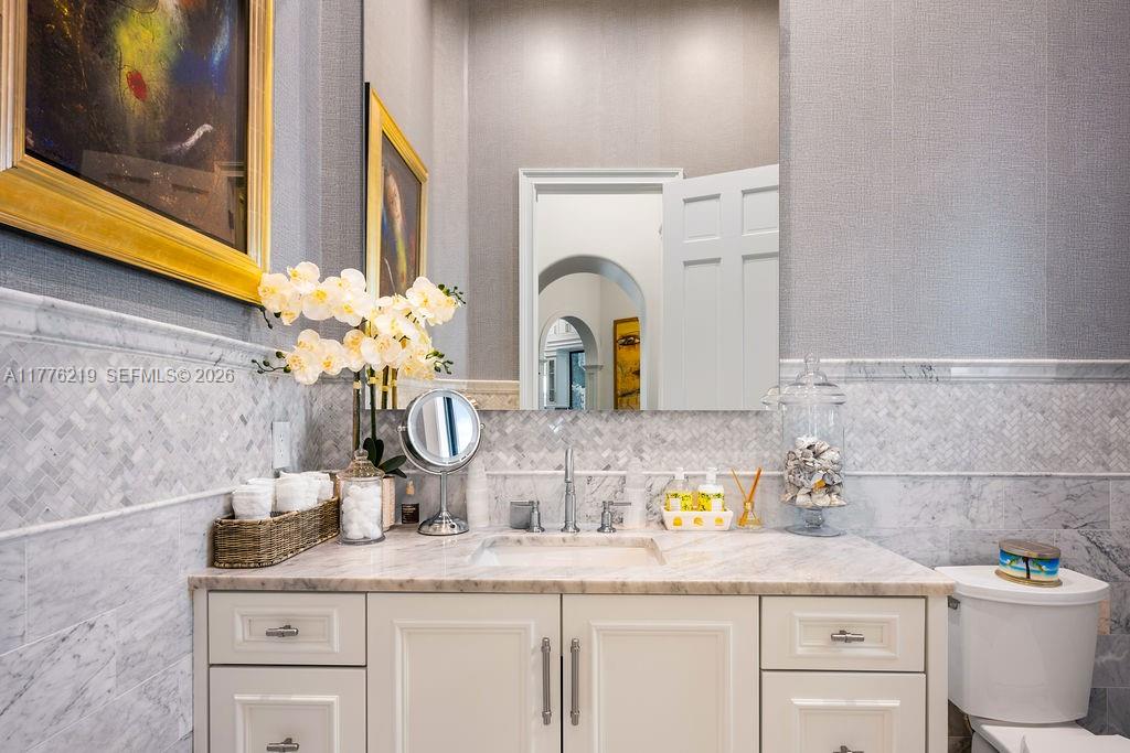 570 Manor Road Maitland, FL 32751 - Photo 54 of 100 a bathroom with a granite countertop toilet sink and mirror
