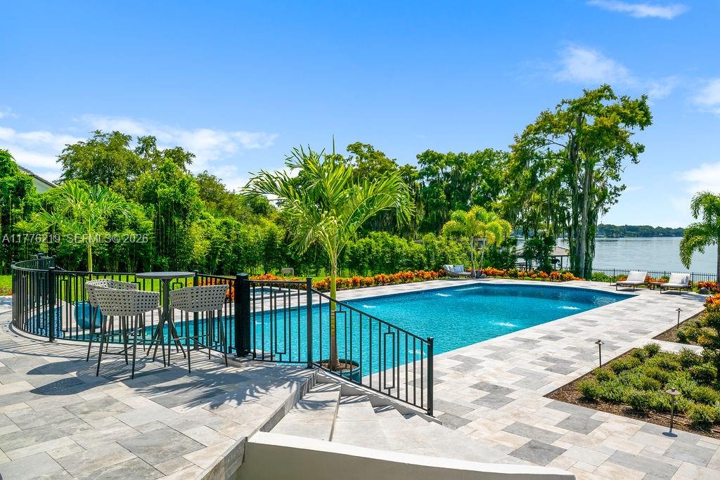 570 Manor Road Maitland, FL 32751 - Photo 60 of 100 a view of a swimming pool with a patio and a yard
