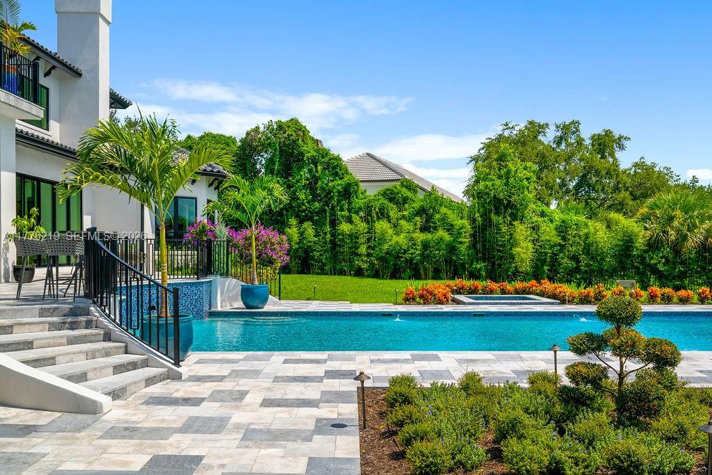 570 Manor Road Maitland, FL 32751 - Photo 76 of 100 a view of swimming pool with lawn chairs plants and large trees