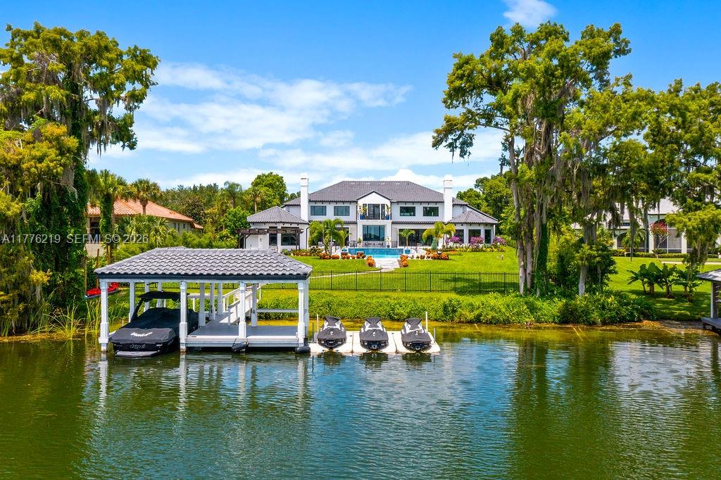 570 Manor Road Maitland, FL 32751 - Photo 83 of 100 a view of a lake with a house swimming pool and outdoor space