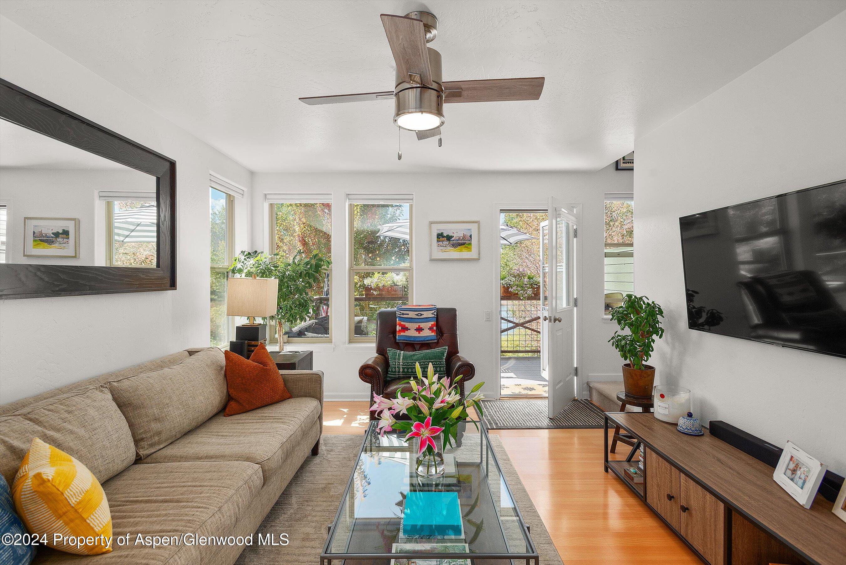 214 Lakeside Drive Basalt, CO 81621 - Photo 9 of 31 a living room with furniture flat screen tv and a large window