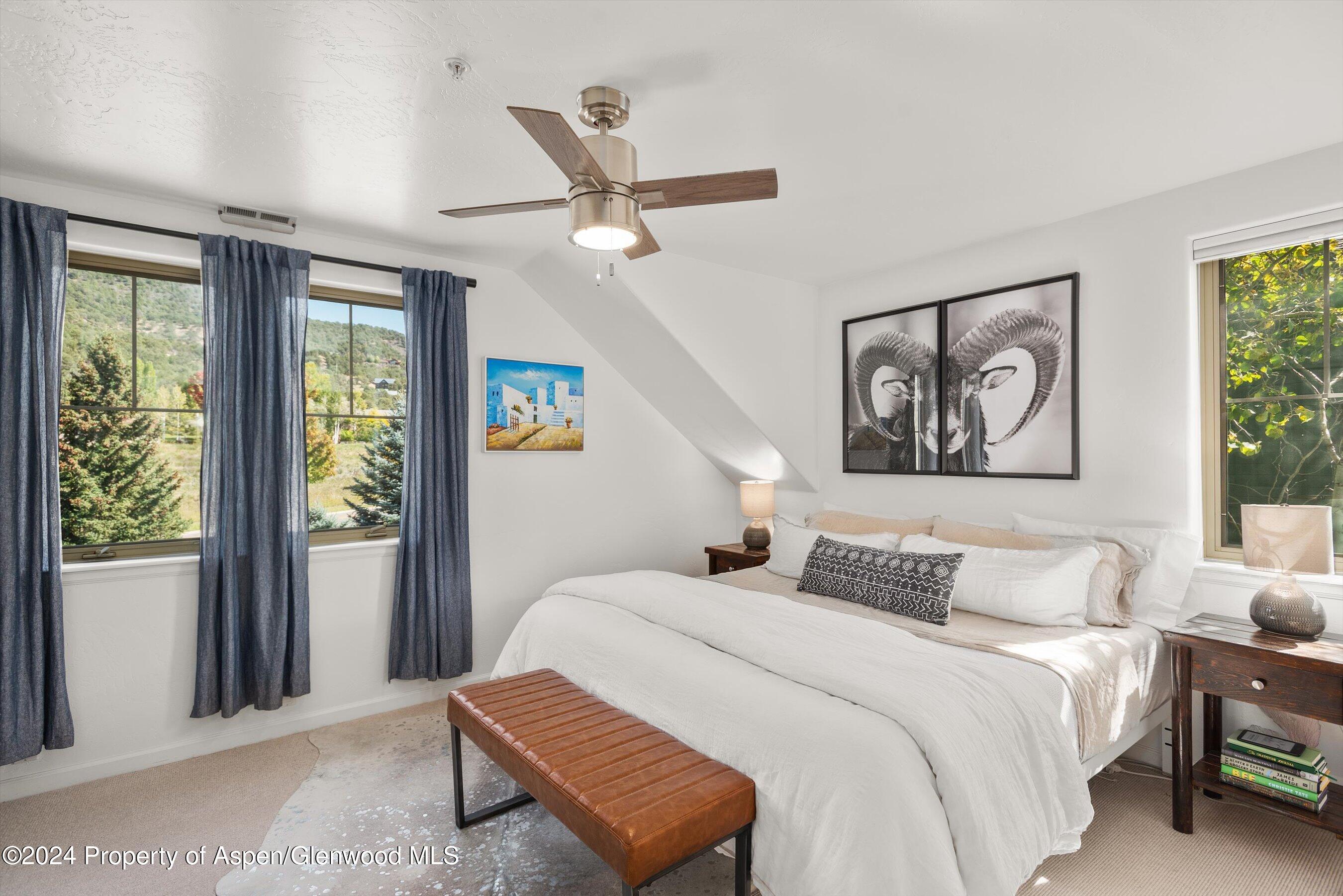 214 Lakeside Drive Basalt, CO 81621 - Photo 13 of 31 a bedroom with a large bed and a window