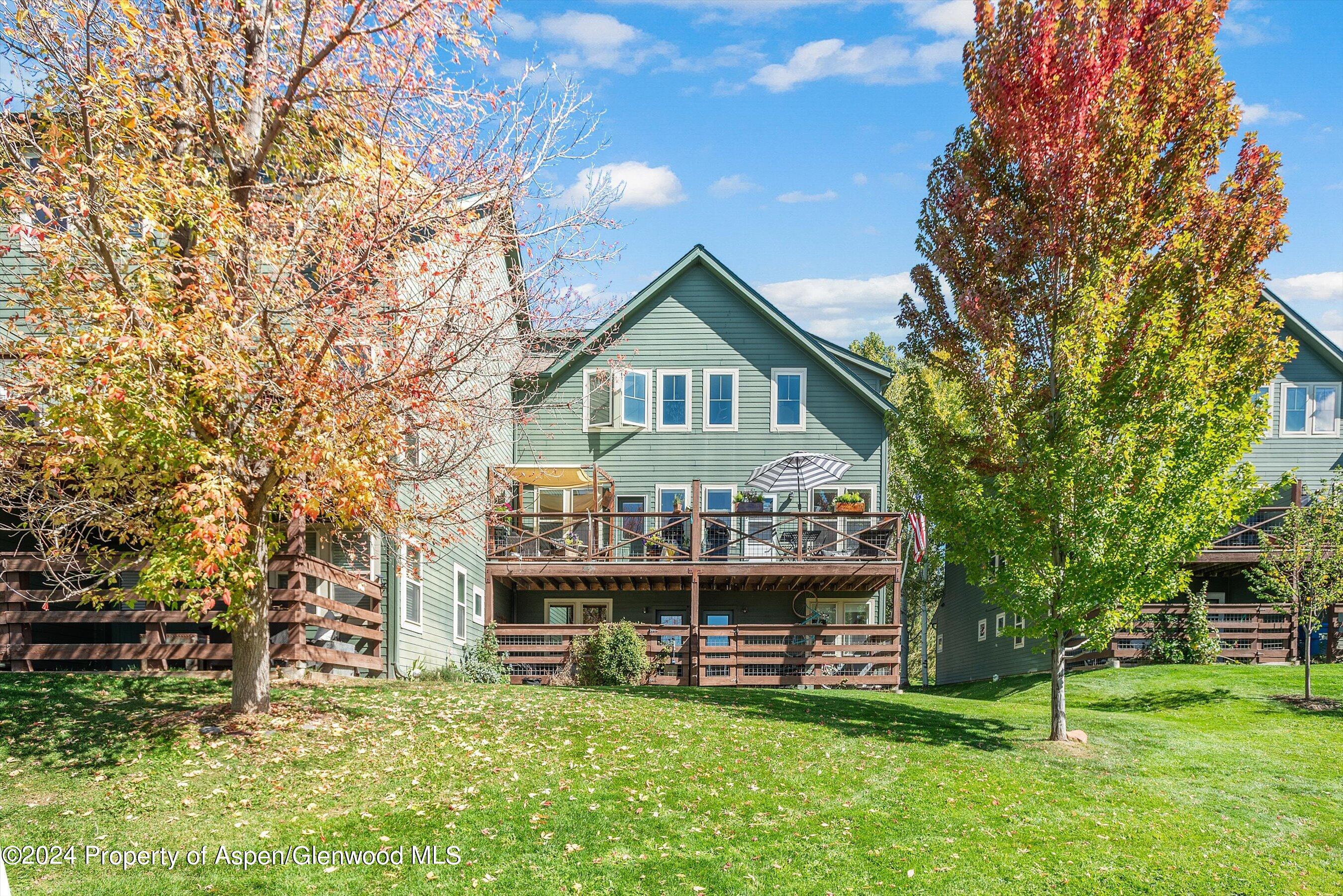 214 Lakeside Drive Basalt, CO 81621 - Photo 24 of 31 a view of a big house with a big yard and large trees