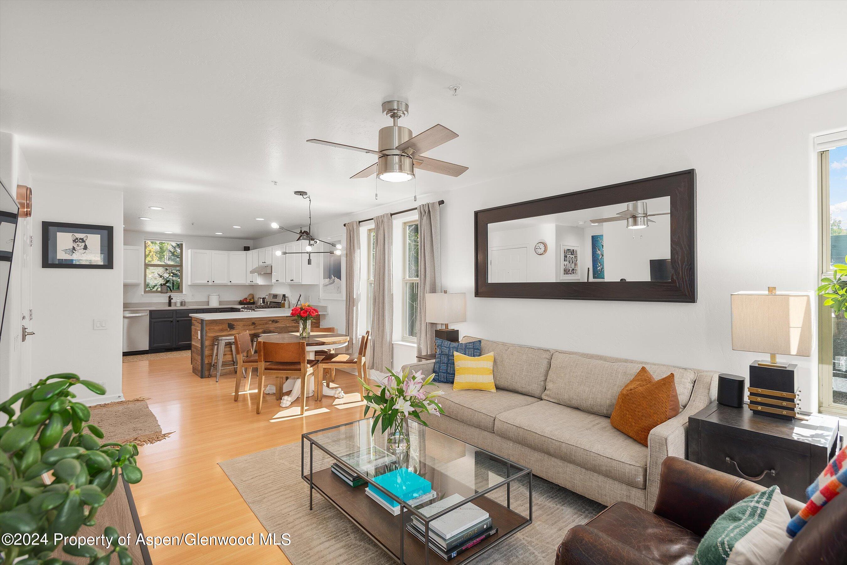 214 Lakeside Drive Basalt, CO 81621 - Photo 31 of 31 a living room with furniture kitchen view and a chandelier