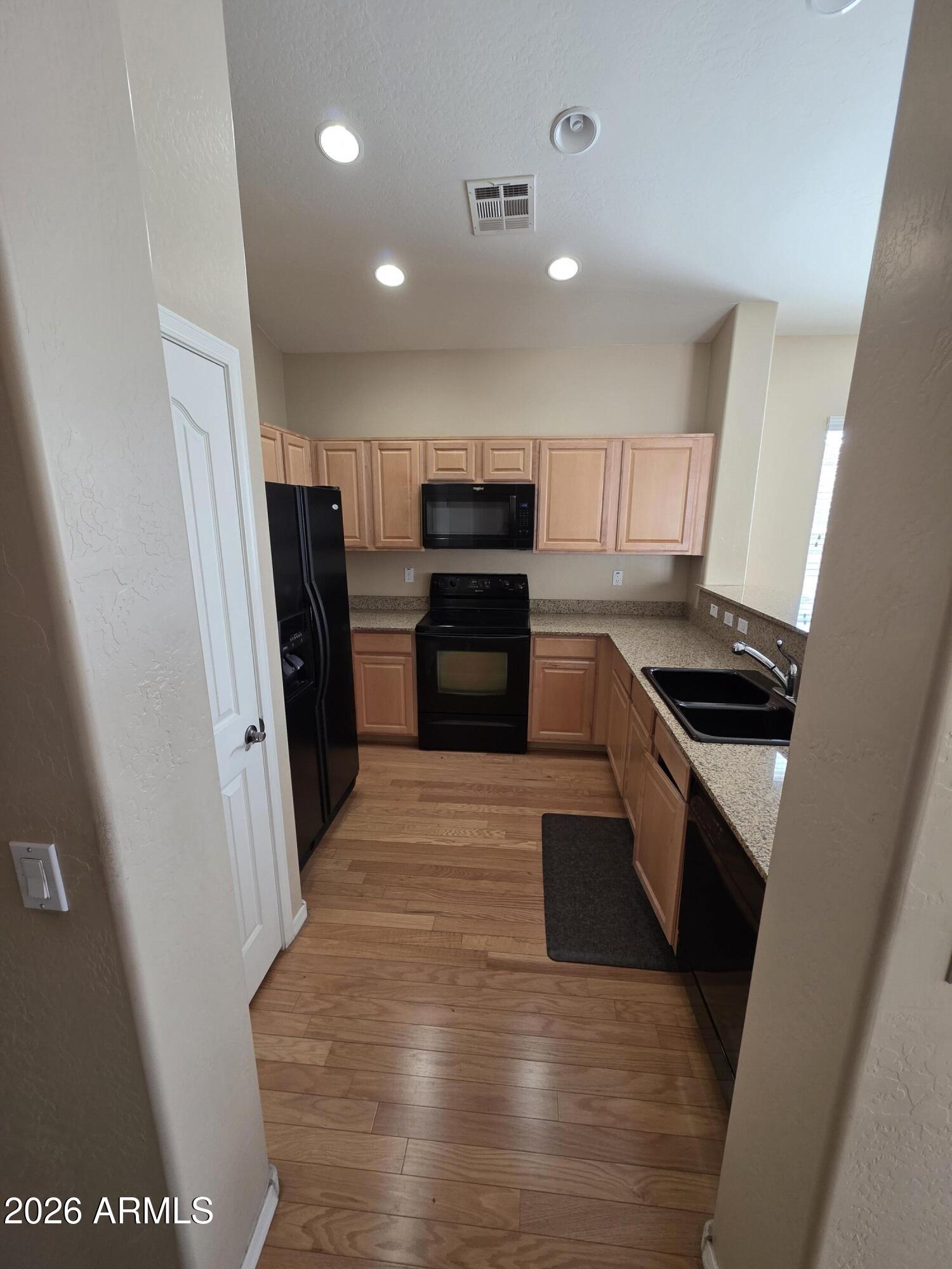 942 West Aspen Way Gilbert, AZ 85233 - Photo 12 of 18 a kitchen with granite countertop a refrigerator and a stove