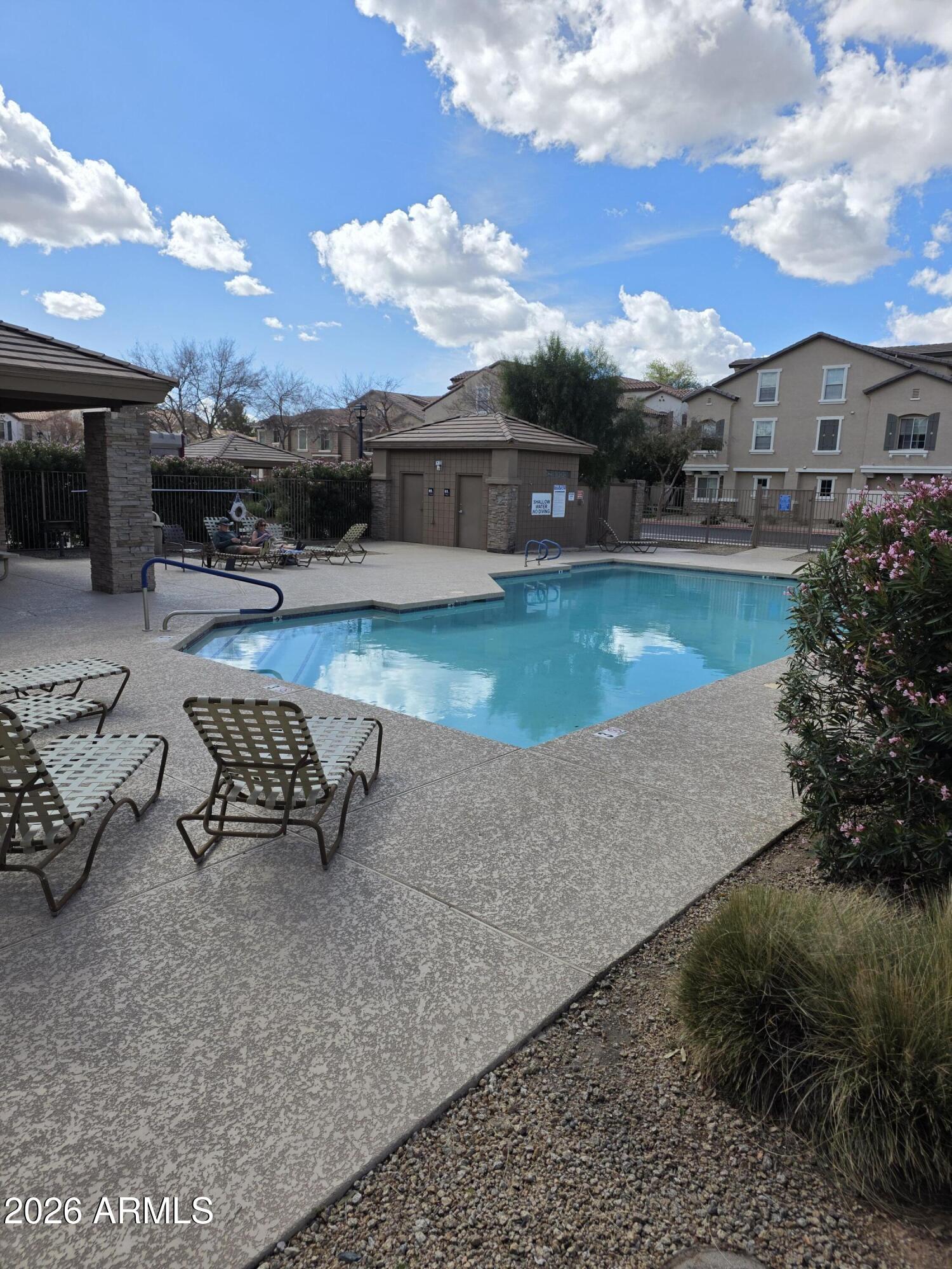 942 West Aspen Way Gilbert, AZ 85233 - Photo 18 of 18 a swimming pool with outdoor seating and a garden