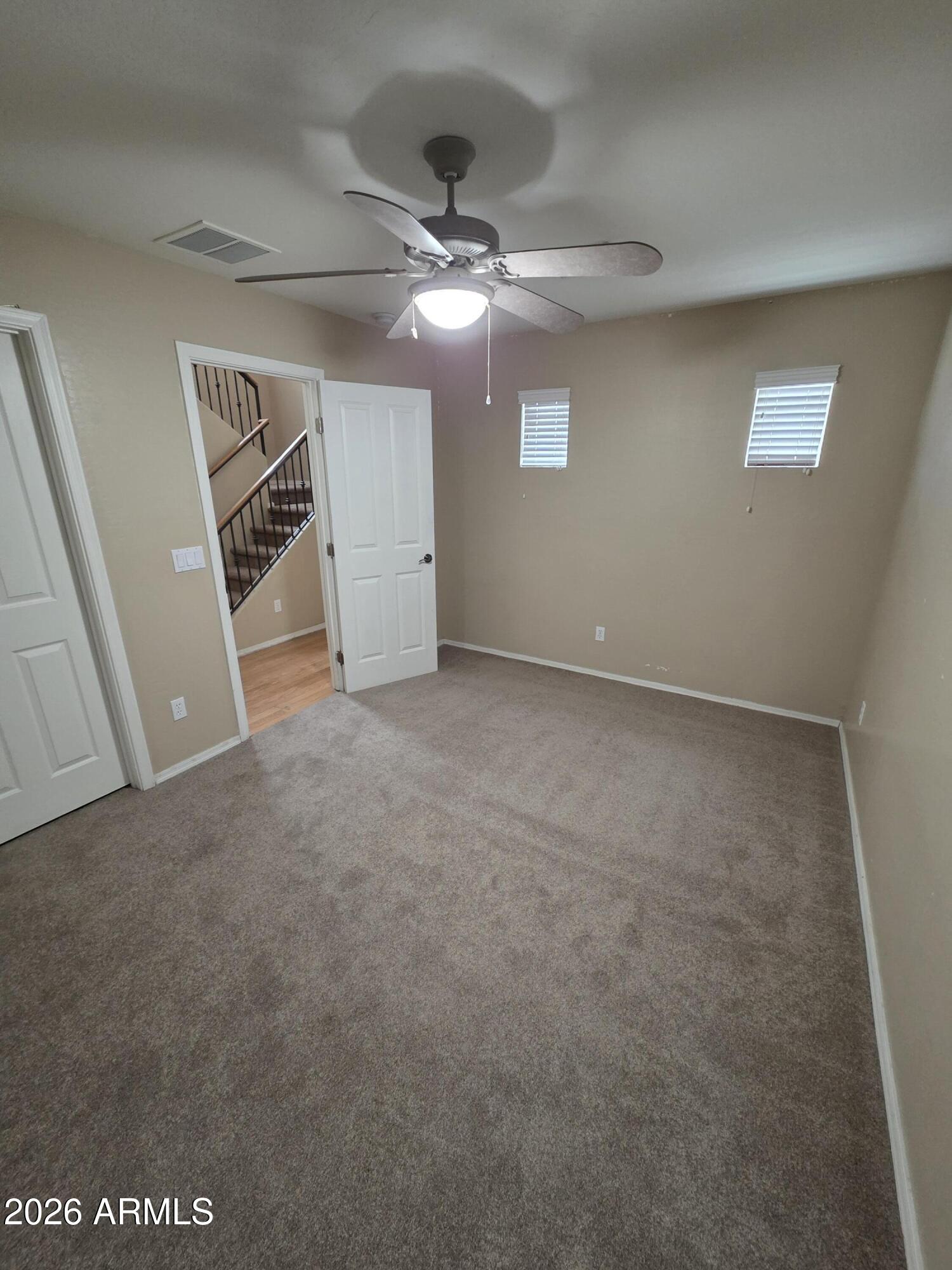 942 West Aspen Way Gilbert, AZ 85233 - Photo 2 of 18 en empty room with windows and ceiling fan
