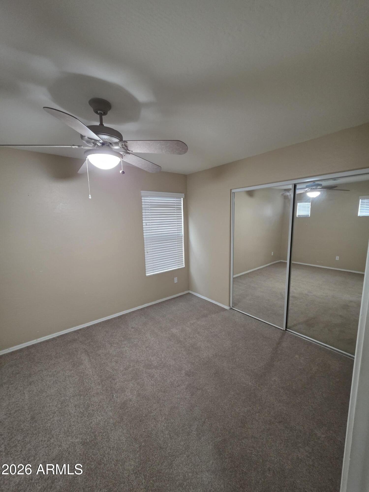 942 West Aspen Way Gilbert, AZ 85233 - Photo 4 of 18 a view of an empty room with a chandelier fan