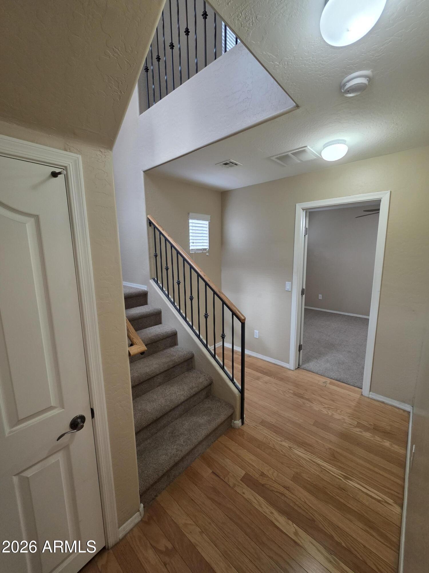 942 West Aspen Way Gilbert, AZ 85233 - Photo 6 of 18 a view of a hallway view with wooden floor and staircase