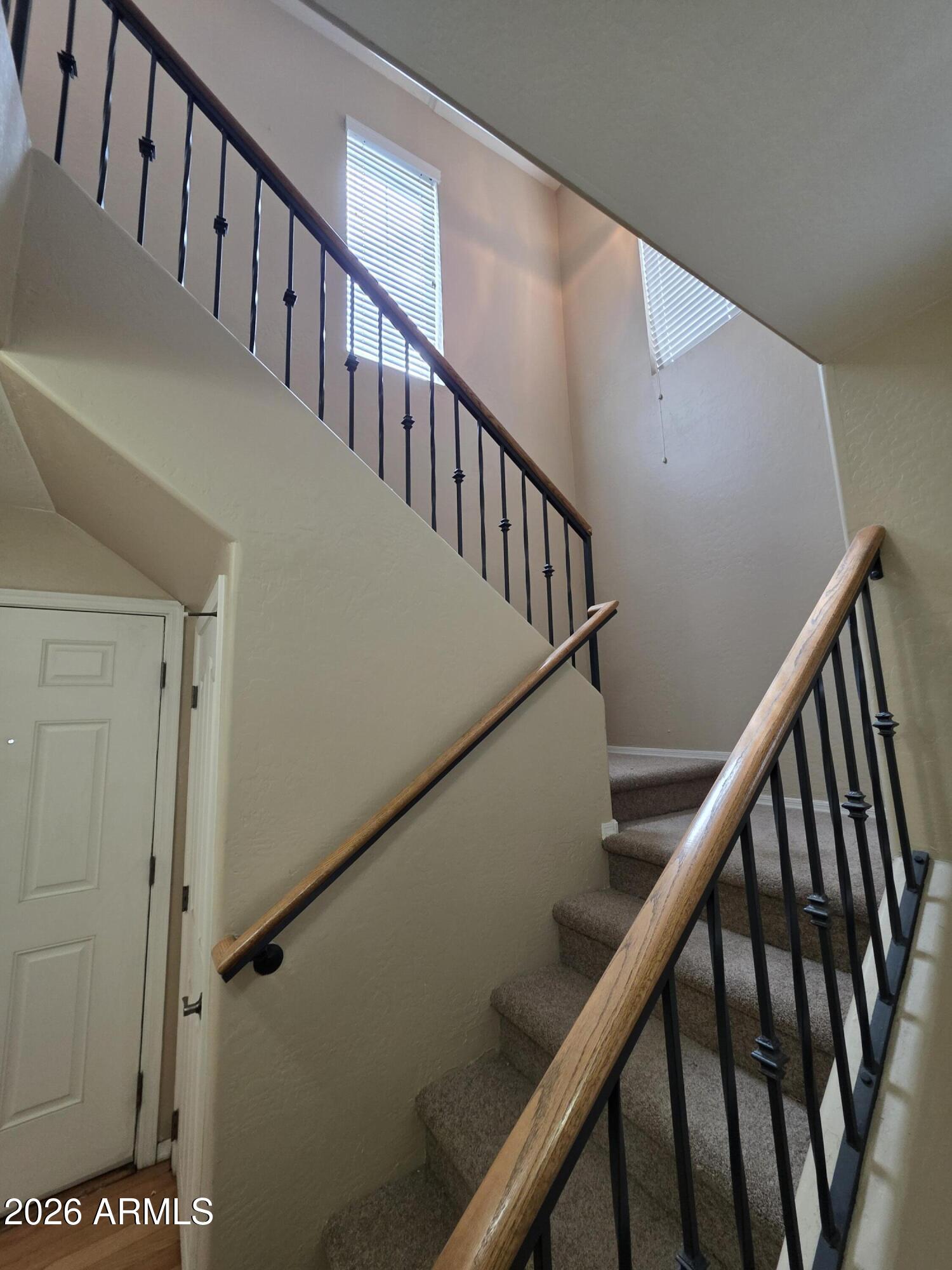 942 West Aspen Way Gilbert, AZ 85233 - Photo 7 of 18 a view of staircase with railing and white walls