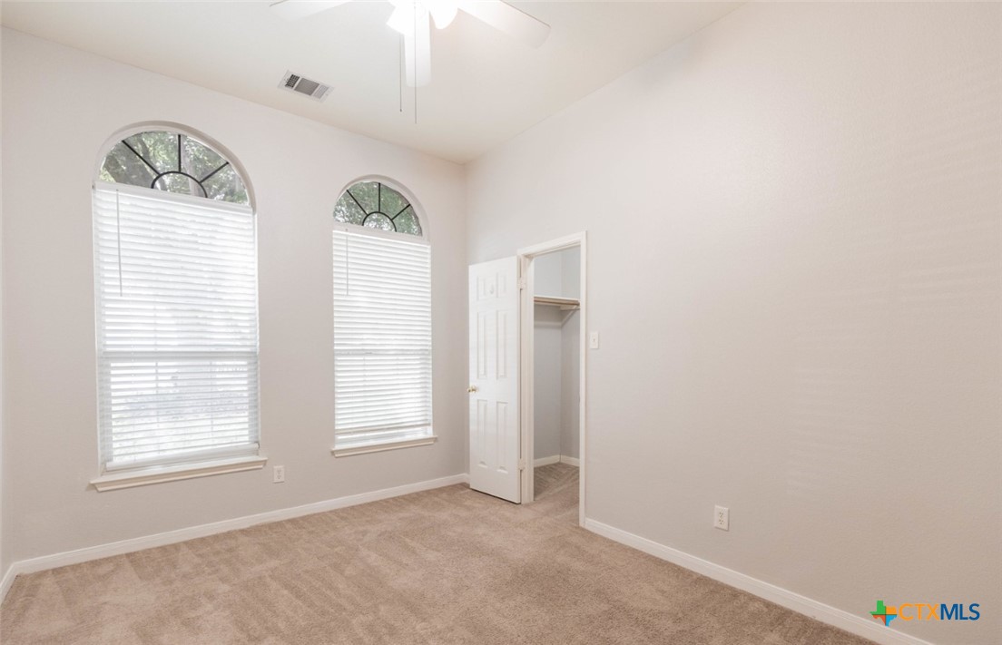 452 Raven Ridge New Braunfels, TX 78130 - Photo 12 of 23 an empty room with windows and wooden floor