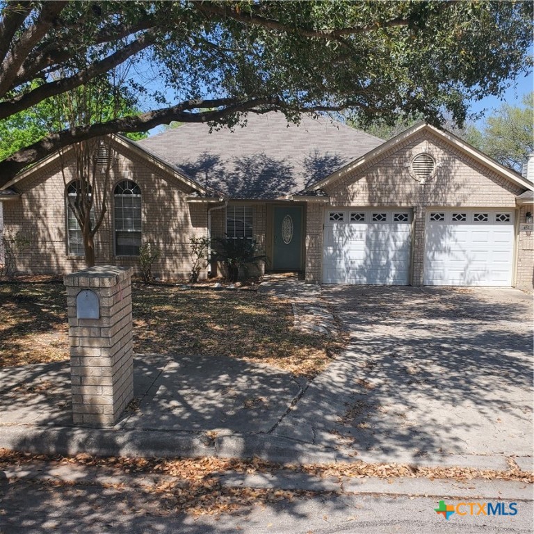 452 Raven Ridge New Braunfels, TX 78130 - Photo 2 of 23 a front view of a house with a yard