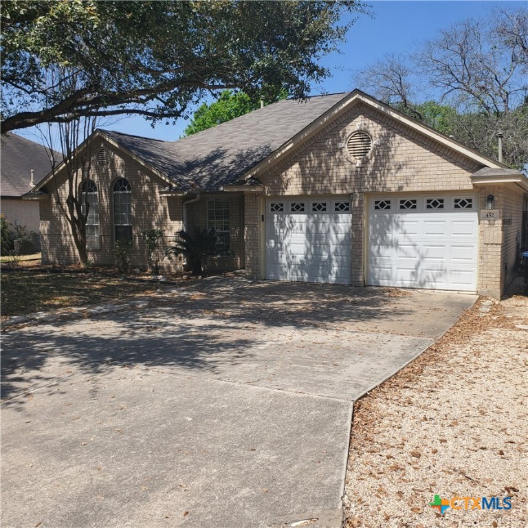 452 Raven Ridge New Braunfels, TX 78130 - Photo 3 of 23 a front view of a house with a yard