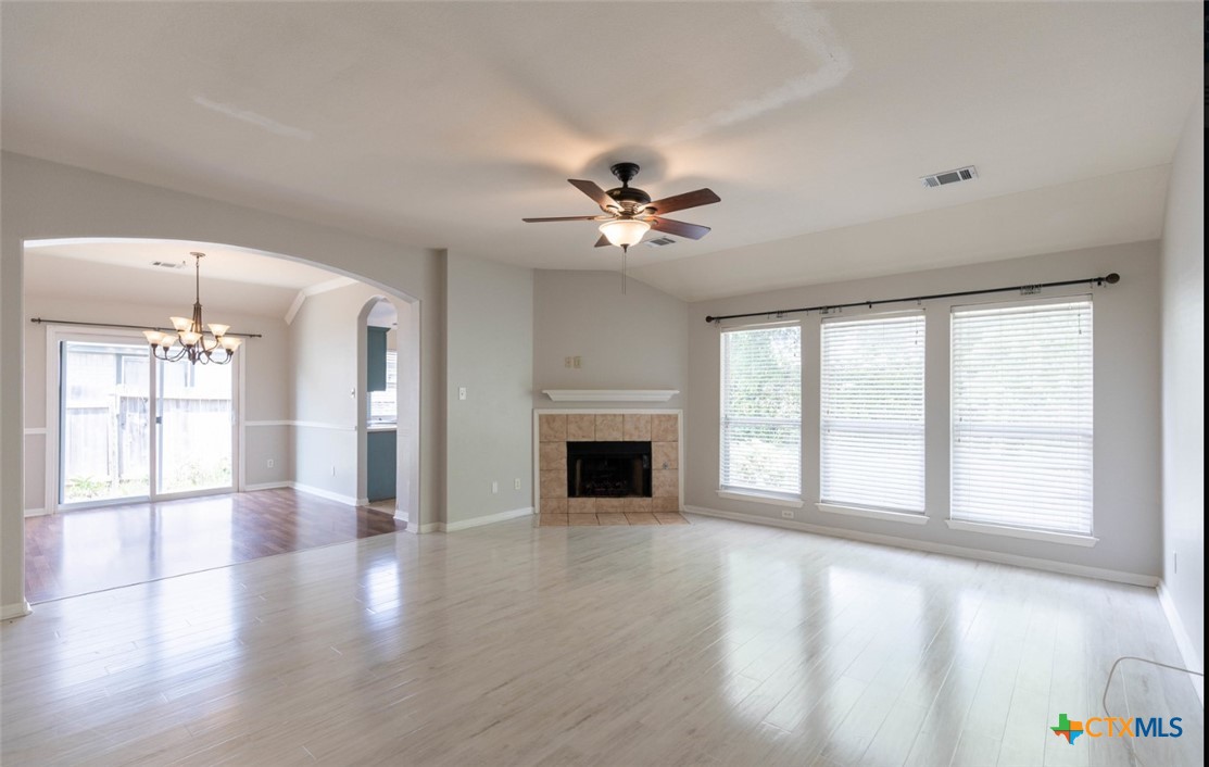 452 Raven Ridge New Braunfels, TX 78130 - Photo 5 of 23 a view of an empty room with a window and wooden floor