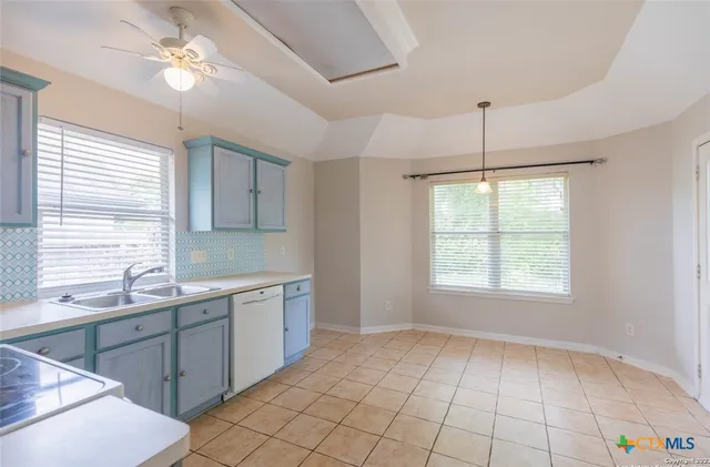 a view of a kitchen with a sink dishwasher and wooden floor