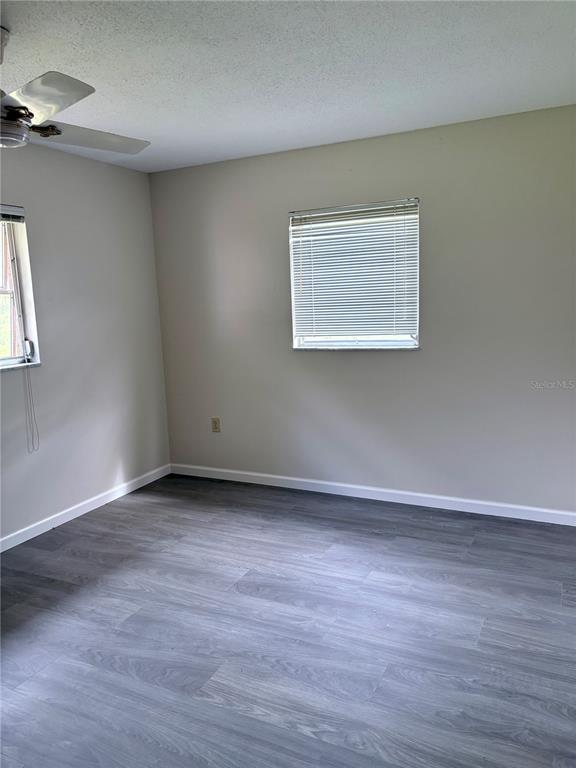 33 Spring Loop Ocala, FL 34472 - Photo 17 of 28 an empty room with wooden floor and windows