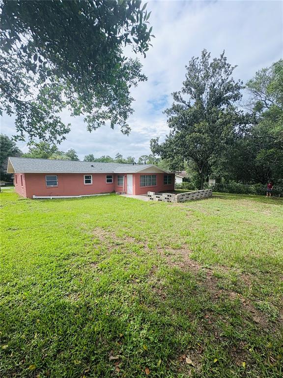 33 Spring Loop Ocala, FL 34472 - Photo 25 of 28 a view of a house with a yard porch and sitting area