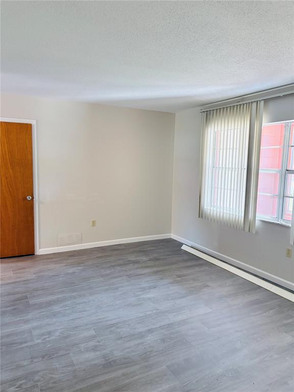 33 Spring Loop Ocala, FL 34472 - Photo 4 of 28 a view of an empty room with wooden floor and a window