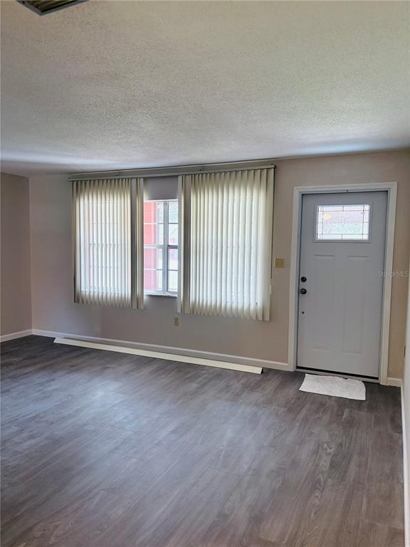 33 Spring Loop Ocala, FL 34472 - Photo 5 of 28 an empty room with wooden floor and windows