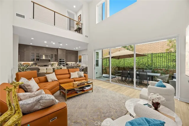 a kitchen with stainless steel appliances granite countertop a table chairs sink and cabinets