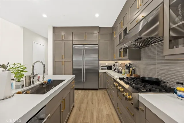 a bathroom with a granite countertop sink a toilet and shower